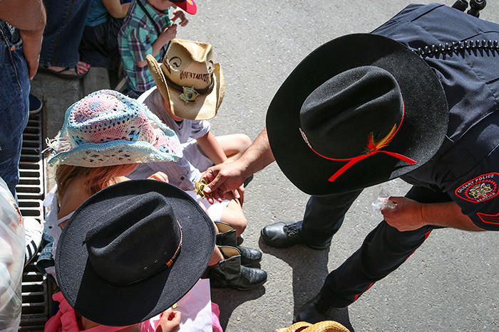 Calgary Police Officer helping children at the Calgary Stampede